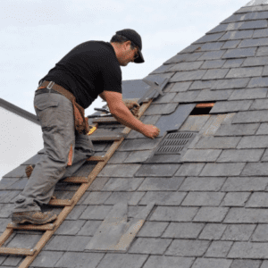 Man replacing shingles on roof